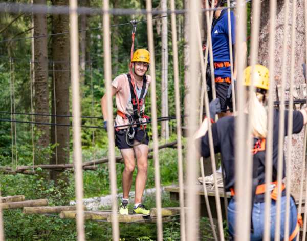 Zwei Jugendliche stehen gemeinsam in der Kletteranlage